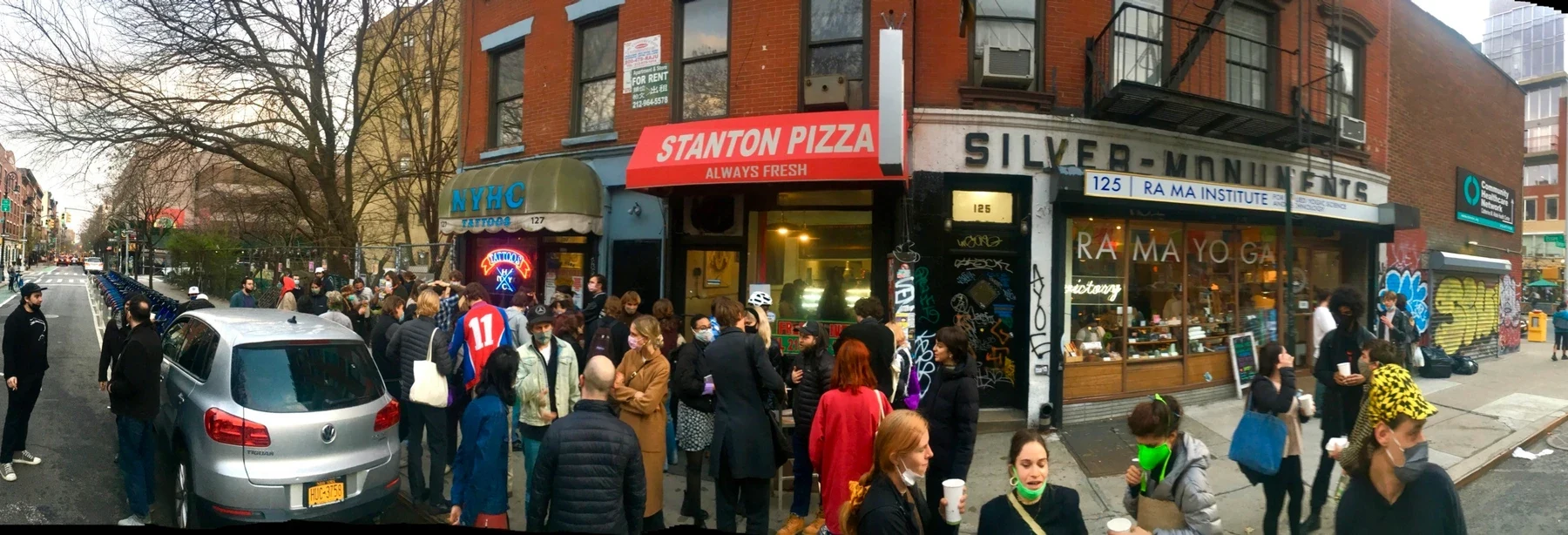 A crowd gathered on the pavement outside Stanton Pizza.