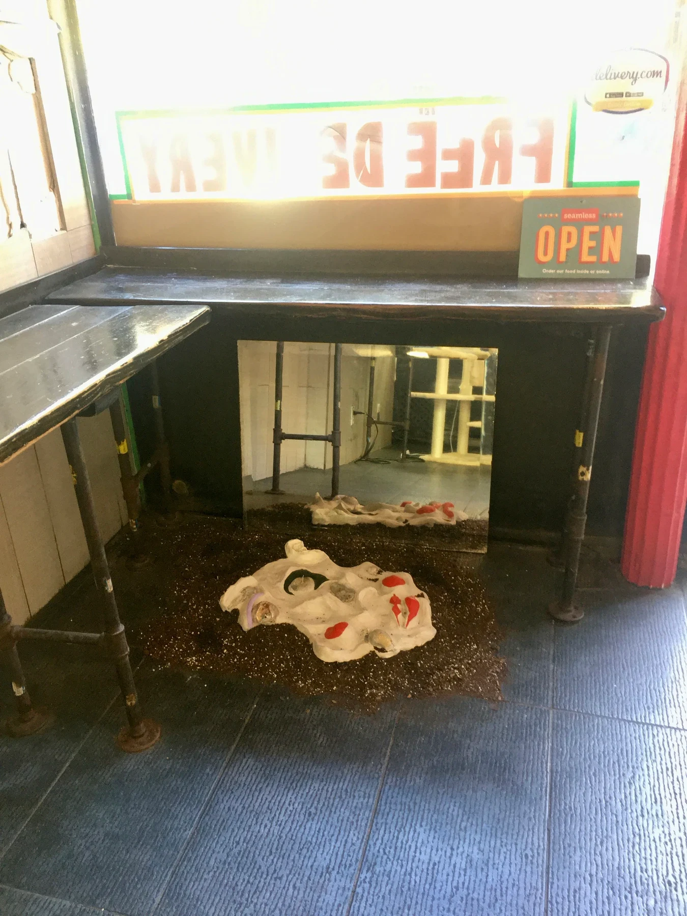 Artwork installed inside the pizza shop window.
