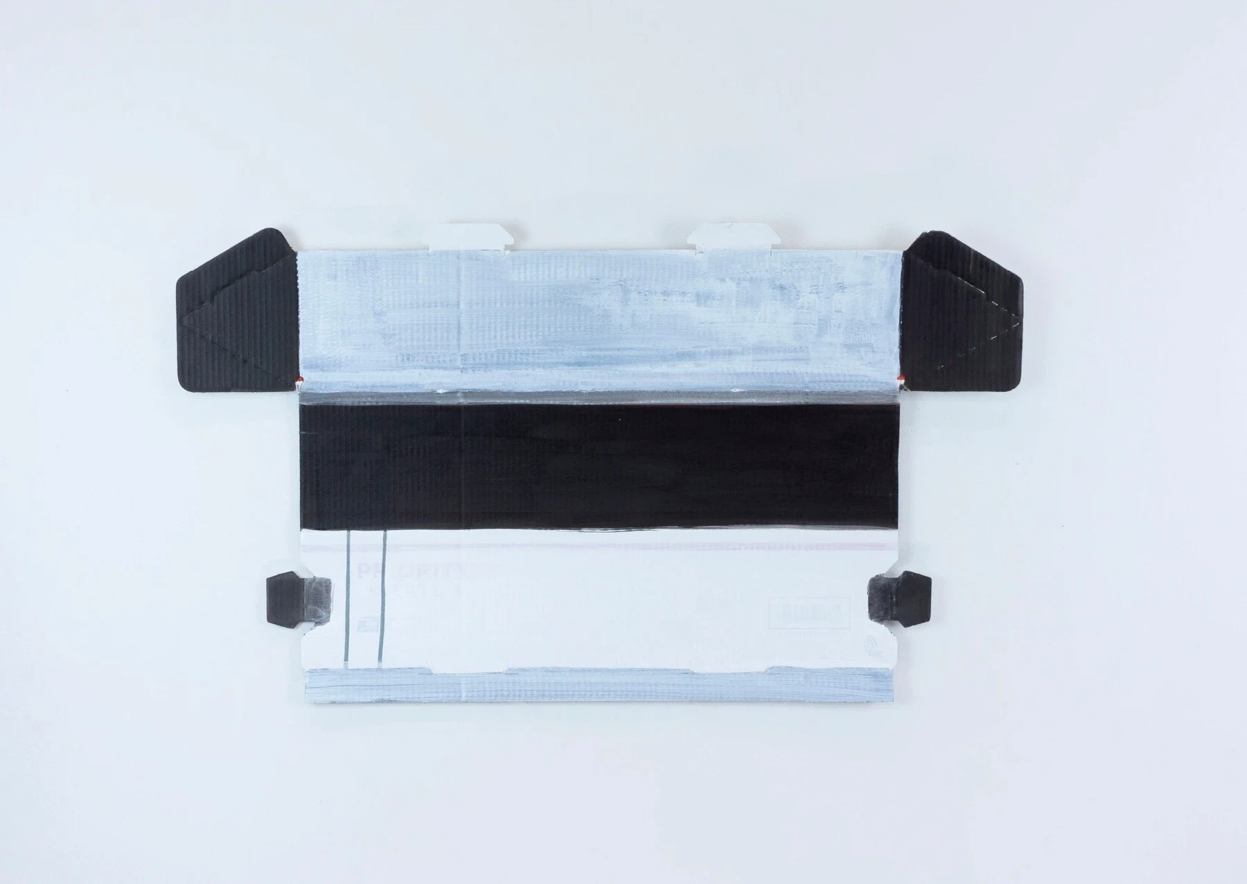An unfolded white box with black side panels and a pale blue center.