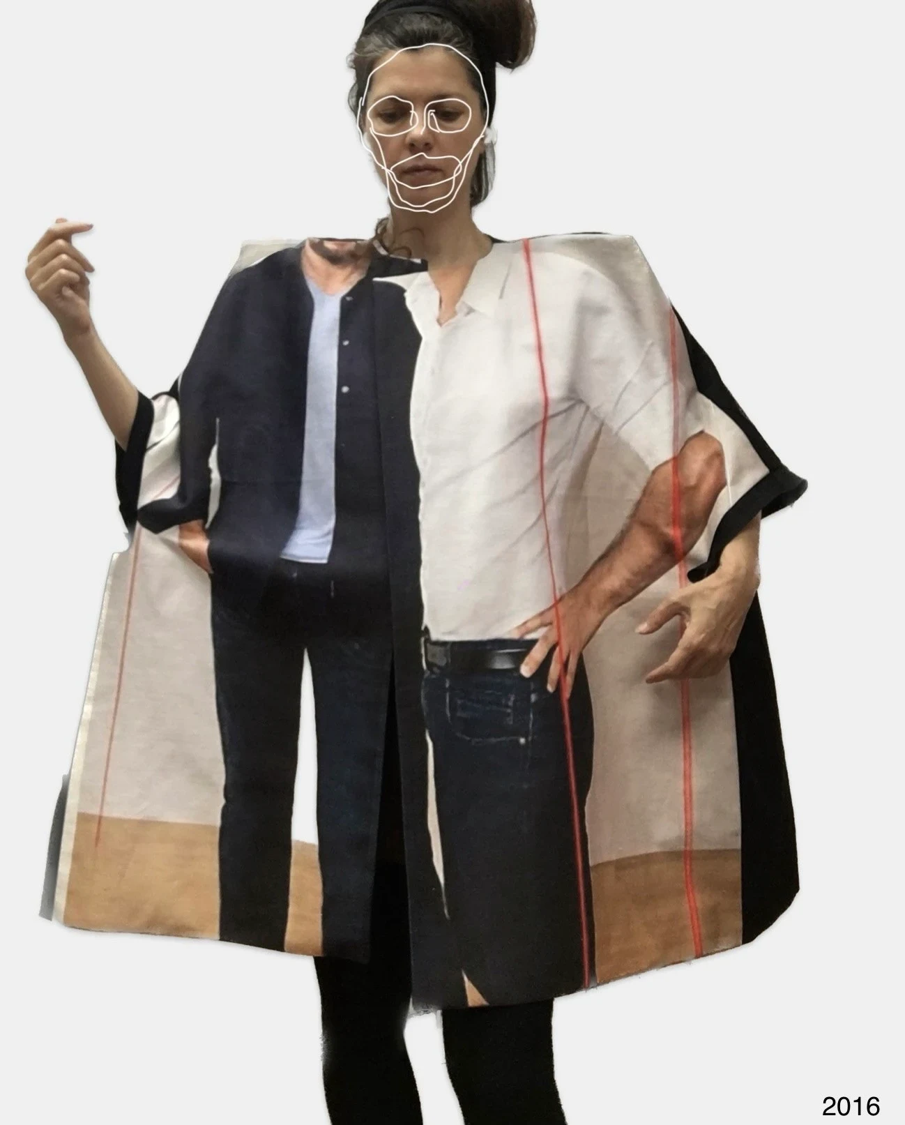 A person holding open a broad black, white and muted pink garment.